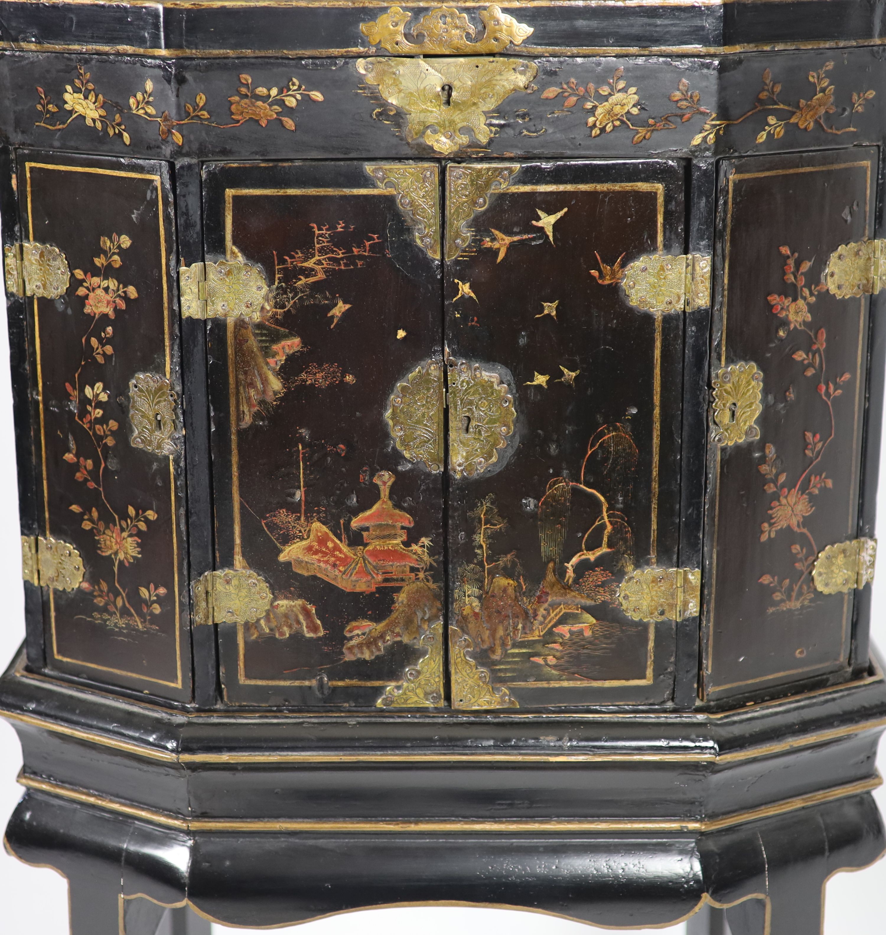 An 18th century Japanese black lacquered table cabinet on stand H 123cm. W 56cm. D 38cm.